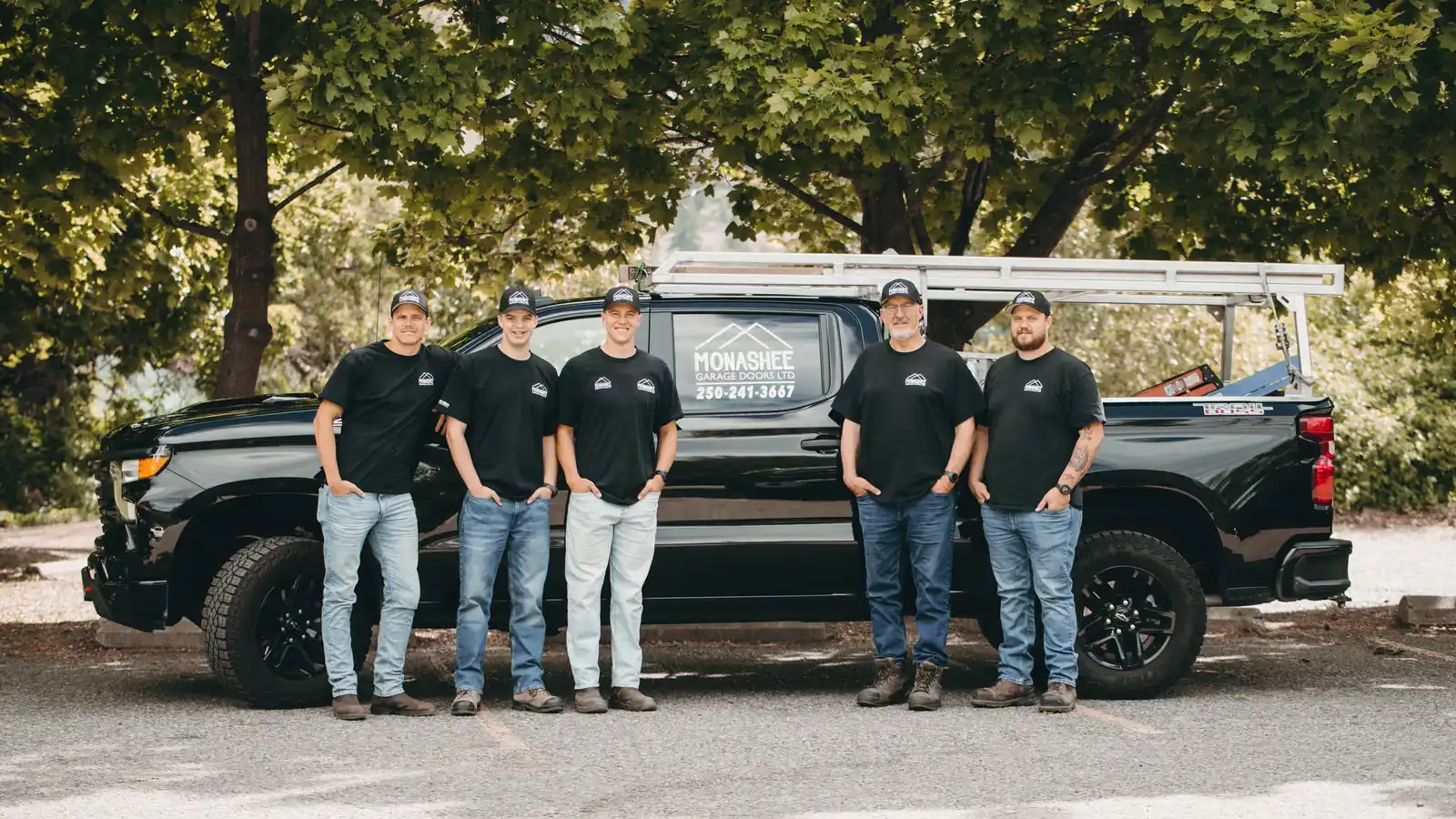 The Monashee Garage Doors crew in front of their branded truck