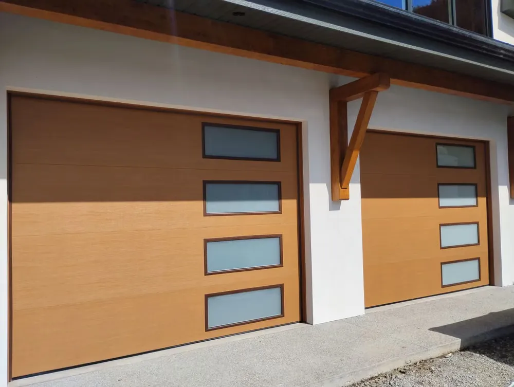 Two wood-look garage doors with vertical window strips under a timber-framed porch